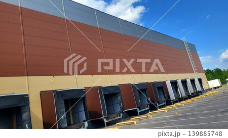 Exterior view of modern industrial loading docks at a distribution center, warehouse infrastructure research, urban logistics study. 139885748