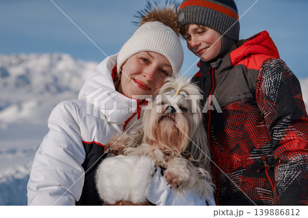 Mother, son and shih tzu dog on winter mountains background Mother, son and shih tzu dog on winter mountains background 139886812