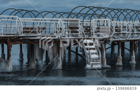 Frozen pier on lake in cold winter season 139886819