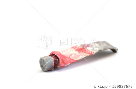 Close-up Old tube of artist oil paint with many colors on white background with copy space Close-up Old tube of artist oil paint with many colors on white background with copy space 139887675
