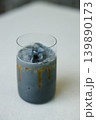 Cup of creation coffee with black charcoal drink on table. 139890173