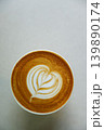 Cup of hot milk latte coffee with heart shape latte art on table. 139890174