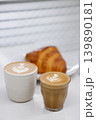 Cup of hot milk piccolo latte coffee and hot cappucino with croissant on white table. 139890181