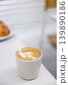 Cup of hot milk Cappuccino with croissant on white table. 139890186