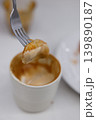 Piece of croissant dipping in a cup of hot Cappuccino. 139890187