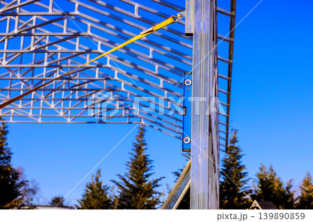 Workers are setting up metal frame for framework assembly building on construction site 139890859