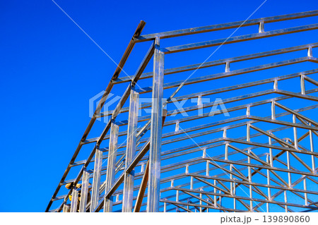 Workers are constructing steel beams frame for assembly building Workers are constructing steel beams frame for assembly building 139890860