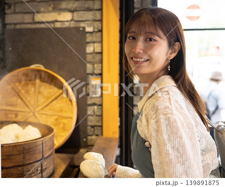 横浜中華街で食べ歩きを楽しむ女性 139891875
