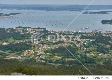 Coastal landscape of the Arousa estuary showing its mussel rafts from the Mirador da Curota viewpoint in Ribeira Coastal landscape of the Arousa estuary showing its mussel rafts from the Mirador da Curota viewpoint in Ribeira 139896060
