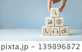 Hand putting and stacking blank wooden cubes on table 139896872