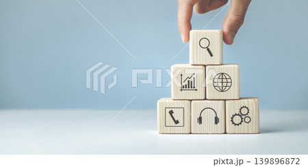 Hand putting and stacking blank wooden cubes on table Hand putting and stacking blank wooden cubes on table 139896872