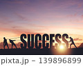 Silhouettes of people drawing the word SUCCESS on a sunset background, business concept 139896899