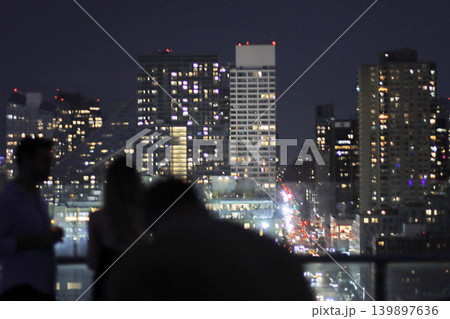 People on a roof terrace in Manhattan at night 139897636