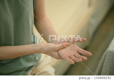 Closeup young woman hand pain her injury pain from cramp, trigger finger, touching massaging, ache joint Closeup young woman hand pain her injury pain from cramp, trigger finger, touching massaging, ache joint 139898292