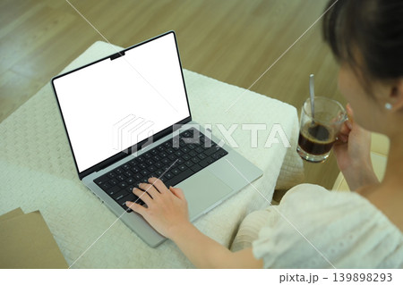 Young woman using laptop to work home, remote work, empty screen with clipping path Young woman using laptop to work home, remote work, empty screen with clipping path 139898293
