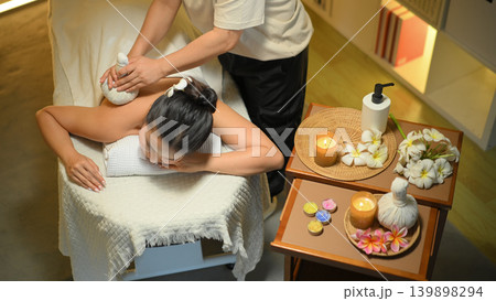 Close up of herbal compress massage on woman back in spa. Well ness concept 139898294