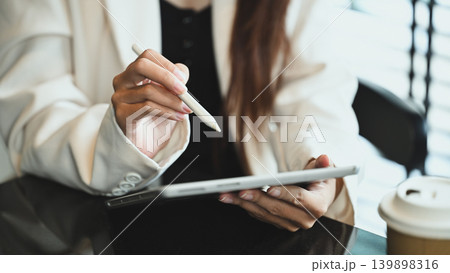 Professional businesswoman in formal wears using digital tablet in modern office 139898316