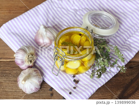 Garlic cloves pickled in olive oil and thyme. 139899036