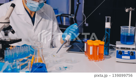 Lab technician experimenting in lab 139899756