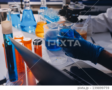 Lab technician experimenting in lab Lab technician experimenting in lab 139899759