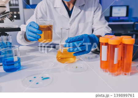 Lab technician experimenting in lab 139899761