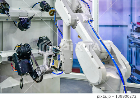 Industrial robotic arm polishing metal part in modern automated factory workstation. Industrial robotic arm polishing metal part in modern automated factory workstation. 139900272