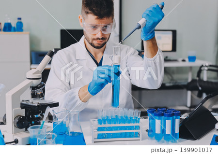 Lab technician experimenting in lab Lab technician experimenting in lab 139901017