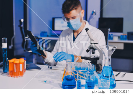 Lab technician experimenting in lab Lab technician experimenting in lab 139901034