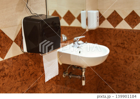 A paper towel dispenser in the restroom A paper towel dispenser in the restroom 139901184