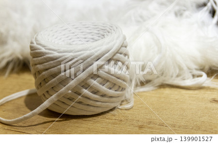 A spool of white cotton rope commonly used for crafts like macrame or as a candle wick A spool of white cotton rope commonly used for crafts like macrame or as a candle wick 139901527