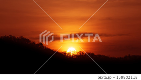 The morning sun rose over the mountains, casting a bright red glow over the sky. The morning sun rose over the mountains, casting a bright red glow over the sky. 139902118