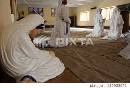 Statue of Mother Teresa in the chapel of the Mother House, Kolkata, India. The statue was made in the pose in which the Mother prayed. Statue of Mother Teresa in the chapel of the Mother House, Kolkata, India. The statue was made in the pose in which the Mother prayed. 139903973
