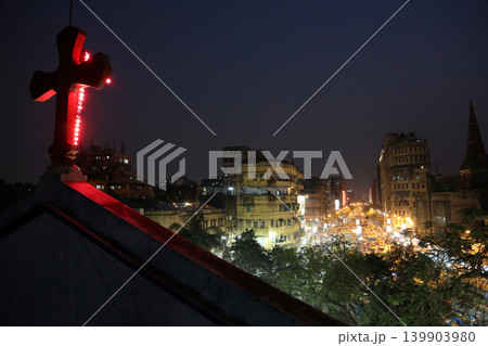 Dark city traffic blurred in motion at late evening on crowded streets, view from the Catholic Cathedral of Kolkata 139903980