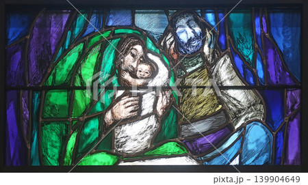 God begins salvation in this world through His Son Jesus Christ, detail of stained glass window by Sieger Koder in St. John church in Piflas, Germany God begins salvation in this world through His Son Jesus Christ, detail of stained glass window by Sieger Koder in St. John church in Piflas, Germany 139904649