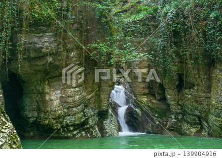 Waterfall in the mountain forest. Nature background. Waterfall in the mountain forest. Nature background. 139904916