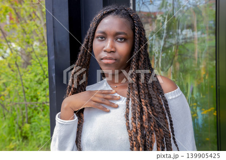 Young African woman waiting at bus stop, urban outdoor portrait Young African woman waiting at bus stop, urban outdoor portrait 139905425