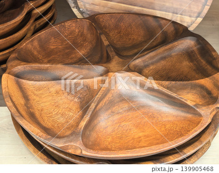 Handcrafted acacia wood divided serving tray with five compartments closeup Handcrafted acacia wood divided serving tray with five compartments closeup 139905468