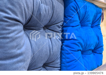 Blue tufted seat cushions close up showing soft velvet upholstery texture Blue tufted seat cushions close up showing soft velvet upholstery texture 139905474