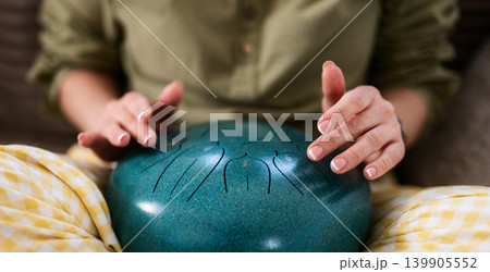 Graceful Female Hands Creating Melody On Handpan Style Tongue Drum 139905552