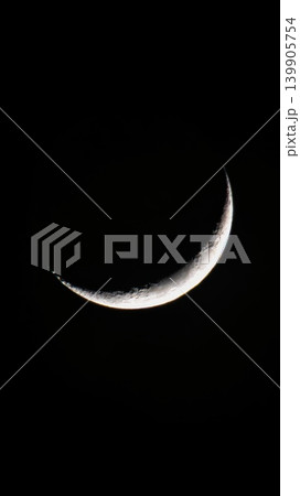 Waxing crescent Moon with crisp cratered relief against night sky Waxing crescent Moon with crisp cratered relief against night sky 139905754