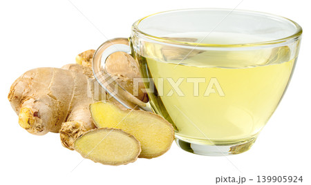 Glass cup of hot ginger tea with fresh ginger root and slices isolated. Healthy herbal beverage for detox and wellness. Natural medicine and organic drink concept. 139905924
