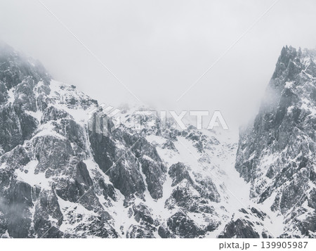 A mountain peak covered with snow. 139905987