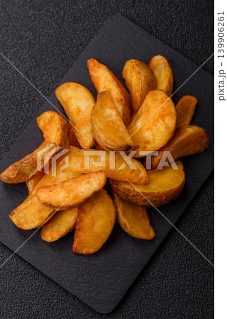 Potato wedges baked with garlic, herbs, and spices for lunch. Potato wedges Potato wedges baked with garlic, herbs, and spices for lunch. Potato wedges 139906261