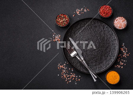 An empty ceramic round plate, kitchen utensils for a dinner table. An empty plate An empty ceramic round plate, kitchen utensils for a dinner table. An empty plate 139906265