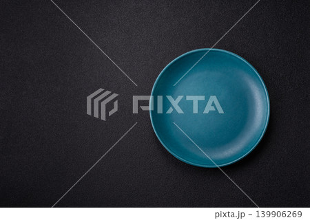 An empty ceramic round plate, kitchen utensils for a dinner table. An empty plate An empty ceramic round plate, kitchen utensils for a dinner table. An empty plate 139906269