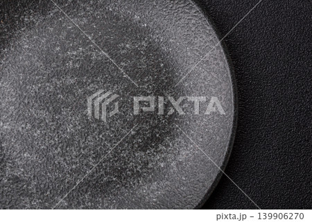 An empty ceramic round plate, kitchen utensils for a dinner table. An empty plate 139906270