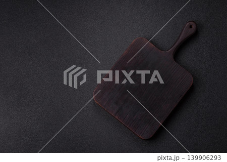 An empty wooden cutting board, kitchen utensils for food preparation. An empty cutting board An empty wooden cutting board, kitchen utensils for food preparation. An empty cutting board 139906293