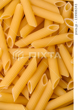 Italian uncooked dry penne regate pasta ready for cooking. Dry penne pasta 139906343