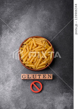 Italian uncooked dry penne regatta pasta with a gluten prohibition sign. The gluten prohibition sign Italian uncooked dry penne regatta pasta with a gluten prohibition sign. The gluten prohibition sign 139906344