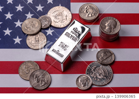 A silver bar, white metal against a backdrop of USA flag, as a concept. A silver bar A silver bar, white metal against a backdrop of USA flag, as a concept. A silver bar 139906365